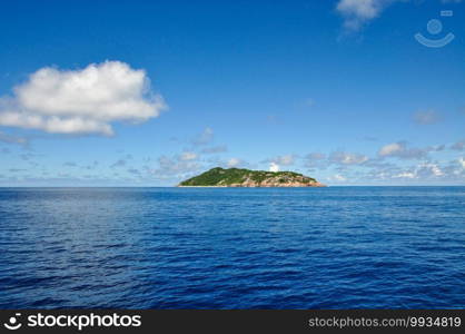 Aride island view from the Indian Ocean with blue sky. Praslin, Seychelles