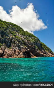 Aride island view from the Indian Ocean with blue sky. Praslin, Seychelles