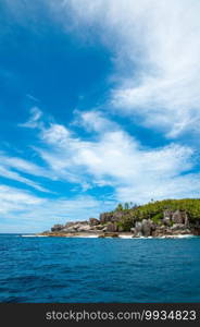 Aride island view from the Indian Ocean with blue sky. Praslin, Seychelles