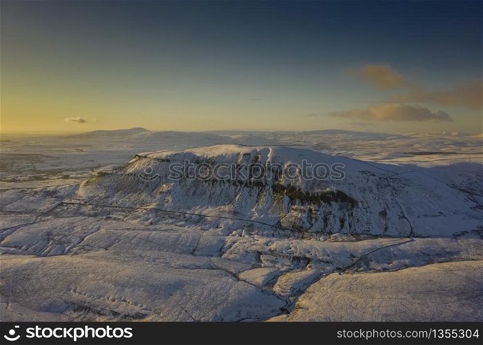 Ariel Shot of penyghent covered in snow