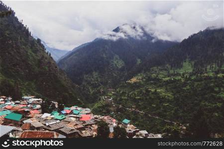 Ariel view of the mountain village of Malana, India. The place lushes with greenery in the summers, but as it is at 10000 ft, conical rooftops are made to stand the snowfalls of the winter.