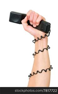Arm and clenched fist, holding a telephone, with the wire wrapped around the arm, illustrating the power of a telephone service, call center or phone terror