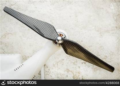 arm of a small quadcopter drone with a carbon fiber propeller