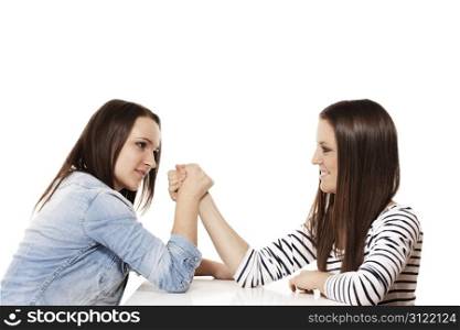 arm wrestling teenager. two pretty arm wrestling teenager on white background