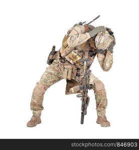 Armed infantryman in camo uniform and helmet embracing head with hands, covering himself from grenade, mine or air bomb explosion, artillery strike danger studio shoot isolated on white background. Infantryman hiding from explosion studio shoot isolated on white