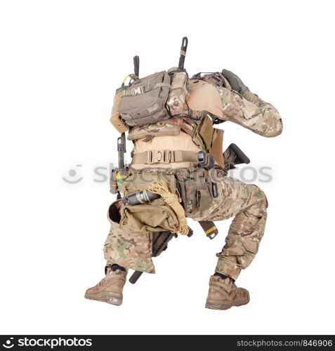 Armed infantryman in camo uniform and helmet embracing head with hands, covering himself from grenade, mine or air bomb explosion, artillery strike danger studio shoot isolated on white background. Infantryman hiding from explosion studio shoot isolated on white