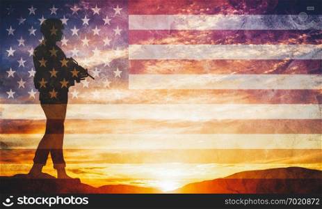 Armed soldier with rifle standing and looking on horizon. USA flag. Silhouette at sunset. War, army, military, guard.. Armed soldier with rifle and USA flag. Guard, army, military, war.