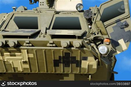armored troop-carrier on the blue sky background