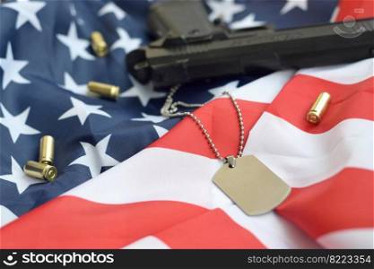 Army Dog tag token with 9mm bullets and pistol lie on folded United States flag. A set of US military veteran items or old duty trophy kit. Army Dog tag token with 9mm bullets and pistol lie on folded United States flag