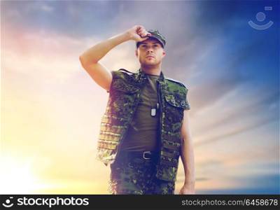 army, national service and people concept - young soldier or ranger wearing military uniform over sky background. soldier in military uniform over sky background