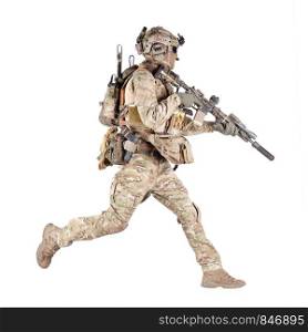 Army soldier, equipped infantryman, airsoft player in camouflage battle uniform, helmet and tactical radio headset jumping, running with assault rifle in hand studio shoot isolated on white background. Running soldier with rifle isolated studio shoot