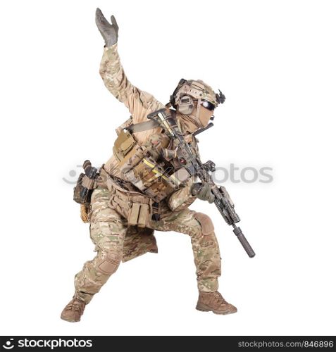 Army soldier, modern combatant, fireteam sergeant in battle uniform and helmet, armed with service rifle, duck under enemy fire, giving follow me arm signal studio shoot isolated on white background. Army soldier going in attack isolated studio shoot