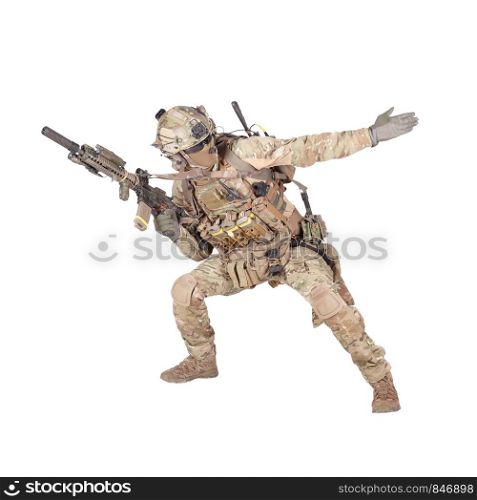 Army soldier, modern combatant, fireteam sergeant in battle uniform and helmet, armed with service rifle, duck under enemy fire, giving follow me arm signal studio shoot isolated on white background. Army soldier going in attack isolated studio shoot