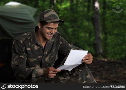 Army soldier reading a letter