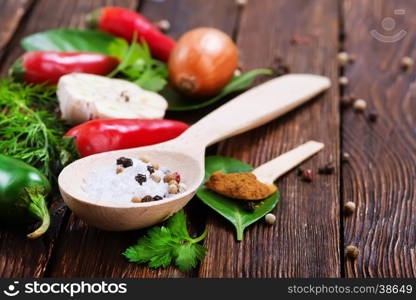 aroma spice in spoon and on the wooden table