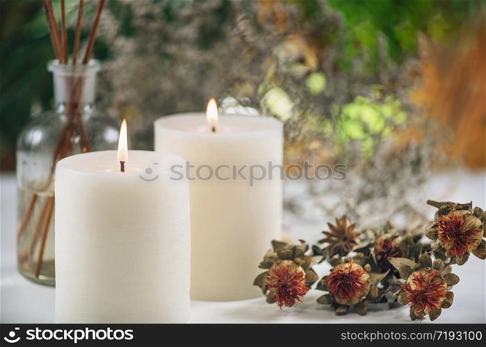 Aromatherapy Concept. Aromatic White Candles and Essential Oil Reed Diffusers