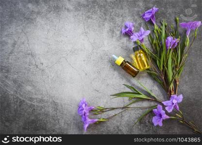 Aromatherapy herbal oil bottles aroma with flower leaves herbal formulations including wildflowers and herbs top view / Essential oils natural and green leaf organic , flat lay