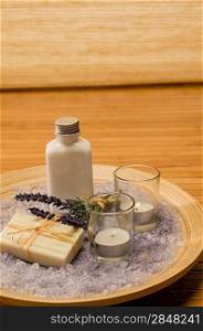 Aromatherapy lavender cosmetic products with candles on wooden tray