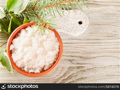 Aromatic bath salt in a clay cup and pumice stone