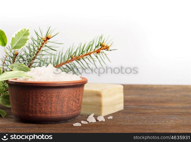 Aromatic bath salt in a clay cup on a wooden background