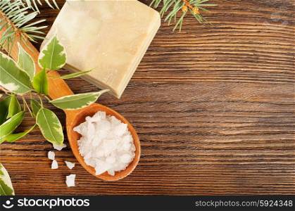 Aromatic bath salt in a wooden spoon and bar of soap