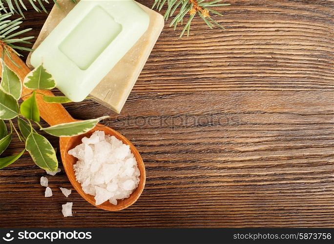 Aromatic bath salt in a wooden spoon and bars of soap
