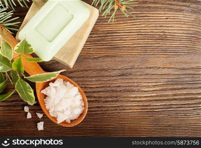 Aromatic bath salt in a wooden spoon and bars of soap