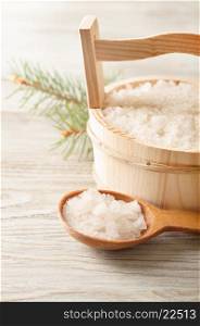 Aromatic bath salt in wooden bucket and spoon