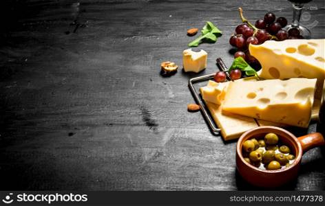Aromatic cheese with olives and red grapes .. Aromatic cheese with olives and red grapes.