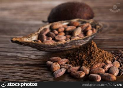 Aromatic cocoa, powder and food dessert background . Cocoa pod on wooden background