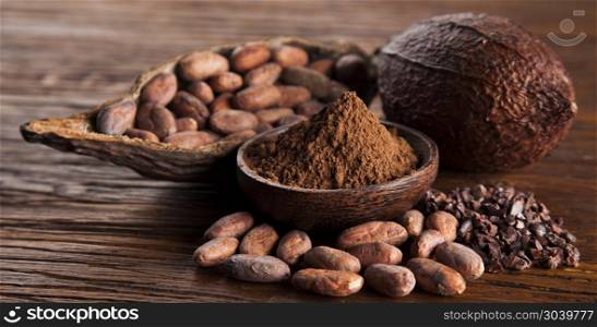 Aromatic cocoa, powder and food dessert background . Cocoa pod on wooden background