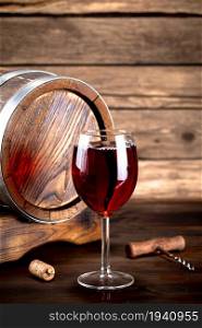 Aromatic grape wine in a glass. On a wooden background.. Aromatic grape wine in a glass.