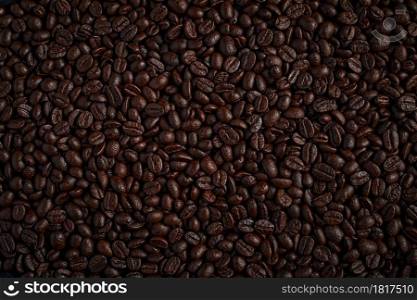 Aromatic roasted coffee beans for background. Coffee beans on dark background