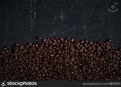 Aromatic roasted coffee beans for background. Coffee beans on dark background