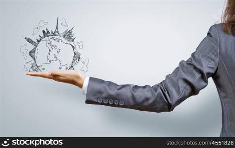 Around the world. Back view of businesswoman holding globe in palm