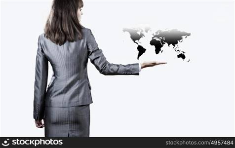 Around the world. Back view of businesswoman holding globe in palm