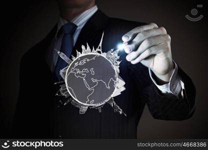 Around the world. Businessman drawing with pencil travelling concept on screen