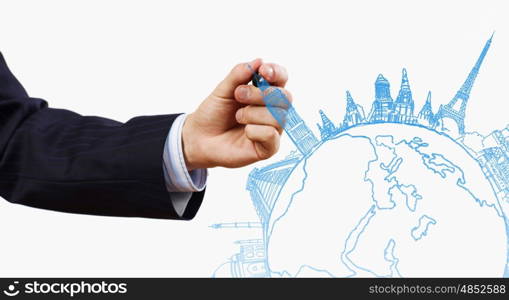 Around the world. Close up of businessman drawing Earth planet
