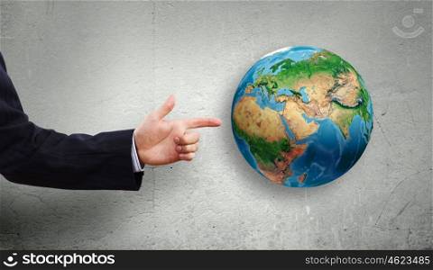 Around the world. Close up of businessman hand pointing on Earth planet . Elements of this image are furnished by NASA
