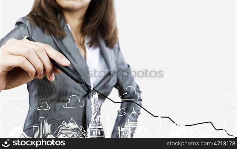 Around the world. Close up of businesswoman drawing graphs and sketches