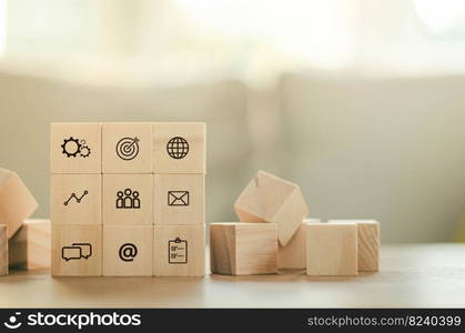 Arrange overlapping wooden blocks with business leaders icons. Key success factors include the world, thought box, inbox, email, internet, goals, preferences, people, business, and statistical graphs.