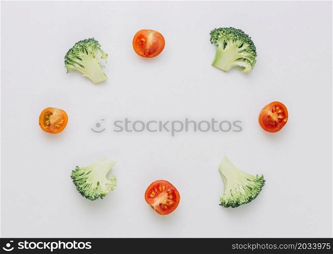 arranged halved broccoli cherry tomatoes circular frame isolated white background