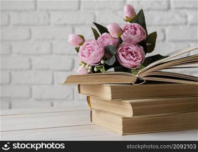 arrangement with books beautiful flowers