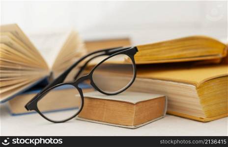 arrangement with books glasses