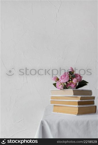 arrangement with books stack flowers