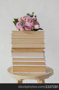 arrangement with books stack roses
