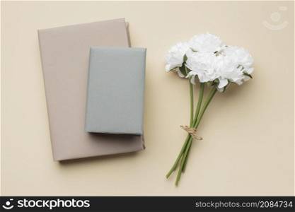 arrangement with books white flowers