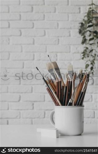 arrangement with brushes pens cup