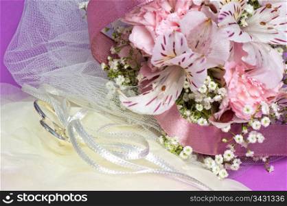 Arrangement with flowers and wedding rings