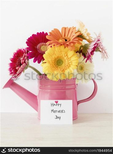 arrangement with flowers watering can. High resolution photo. arrangement with flowers watering can. High quality photo